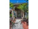 Close-up of a beautiful front door with decorative glass and potted plants at 1516 E Lake Woodlands Pkwy, Oldsmar, FL 34677