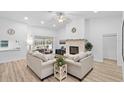 Bright living room with high ceilings, a cozy fireplace, and sliding glass doors for seamless indoor-outdoor living at 1562 Coastal Pl, Dunedin, FL 34698