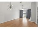 Spacious living room with ample natural light and modern lighting fixture at 16109 Rambling Vine E Dr, Tampa, FL 33624