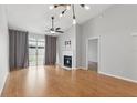 Bright living room with hardwood floors, a fireplace, and sliding glass doors at 16109 Rambling Vine E Dr, Tampa, FL 33624