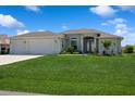 Charming single Gathering home with a lush green lawn, and a three-car garage at 180 Rotonda N Blvd, Rotonda West, FL 33947