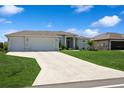Charming single Gathering home with a lush green lawn, three-car garage, and a long driveway at 180 Rotonda N Blvd, Rotonda West, FL 33947