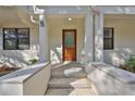Inviting front entryway with a modern wood door, concrete steps, and white siding at 1801 N Morgan St # 5, Tampa, FL 33602