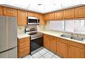 Bright kitchen with stainless steel appliances, light countertops, and wooden cabinets at 2593 Countryside Blvd # 7305, Clearwater, FL 33761