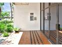Lobby entrance showcasing tile flooring, stucco walls, and a glass door at 2593 Countryside Blvd # 7305, Clearwater, FL 33761