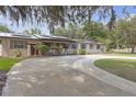 Charming single-story home with solar panels, mature landscaping, and a circular driveway at 2704 Dorene Dr, Plant City, FL 33563