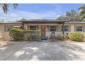 Charming single-story home with an inviting front porch and mature landscaping at 2704 Dorene Dr, Plant City, FL 33563
