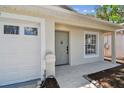 Close up of the home's entrance, showcasing the front door, adjacent garage and the walkway to the front door at 2742 Wilson Ct, Palm Harbor, FL 34684