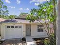 Charming single-story home featuring lush landscaping, a one-car garage, and a welcoming front entrance at 2742 Wilson Ct, Palm Harbor, FL 34684