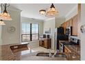 Well-lit kitchen with stainless steel appliances, granite countertops, and a window with a water view at 2773 Via Cipriani # 1310A, Clearwater, FL 33764