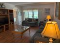 Cozy living room with comfortable seating, wood floors, and lots of natural light at 303 Meadow Ln, Oldsmar, FL 34677