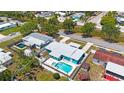 Aerial view of the property featuring a private pool, fenced yard and lush greenery at 3215 58Th N St, St Petersburg, FL 33710