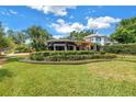 Lush landscaping surrounds this bright yellow home, enhancing its curb appeal at 356 20Th Ne Ave, St Petersburg, FL 33704