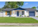 Charming single-story home featuring a well-manicured lawn, fresh exterior paint and inviting curb appeal at 3709 Danny Bryan Blvd, Tampa, FL 33619