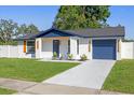 Charming single-story home featuring a well-manicured lawn, fresh exterior paint and inviting curb appeal at 3709 Danny Bryan Blvd, Tampa, FL 33619