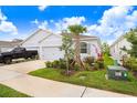 Charming single-story home with a well-manicured lawn, a two car garage, and a beautiful palm tree at 3719 Stormy Thistle Pl, Plant City, FL 33565