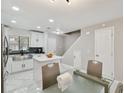 Modern eat-in kitchen featuring white cabinets, stainless steel appliances and a center island at 4017 Cedar Limb Ct, Tampa, FL 33614