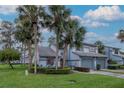Beautiful home with mature palm trees, lush lawn, and two-car garage, showcasing the property's curb appeal at 4234 Brentwood Park Cir, Tampa, FL 33624