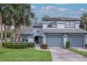 Inviting two-story home with a well-manicured lawn, lush landscaping, and an attached two-car garage at 4234 Brentwood Park Cir, Tampa, FL 33624