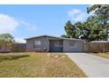 Charming single-story home features a well-maintained front yard and neutral gray exterior at 4521 W North St, Tampa, FL 33614