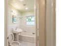 Bright bathroom with a classic pedestal sink and a tiled bathtub/shower combination at 4611 17Th N Ave, St Petersburg, FL 33713