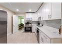 Well-lit kitchen with sleek appliances, white cabinets, and a view into the dining area at 4611 17Th N Ave, St Petersburg, FL 33713