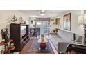 Cozy living room featuring a sofa, TV, ceiling fan, and access to an outdoor patio at 512 Hillpine Way, Brandon, FL 33510