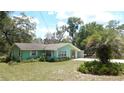 Charming single-story home featuring a well-manicured lawn and a sunny facade at 5287 Azalea Cir, Dade City, FL 33523