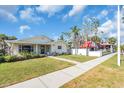 A quaint house with lush front yard, and sidewalk views, next to other businesses at 5713 Shore S Blvd, Gulfport, FL 33707