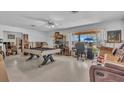 Spacious living room featuring a pool table, large window, and comfortable seating area at 5713 Shore S Blvd, Gulfport, FL 33707
