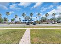 Scenic street view showcasing lush green spaces and distant water views near parking spots at 5713 Shore S Blvd, Gulfport, FL 33707