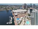Expansive aerial view of a waterfront entertainment complex with a pool and the city skyline in the background at 612 Arbor Lake Ln, Tampa, FL 33602