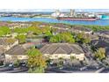 Scenic aerial view of townhomes, a tennis court, and the waterway beyond the lush trees in the Island Walk community at 612 Arbor Lake Ln, Tampa, FL 33602