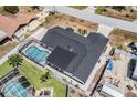 Aerial view of the property with a fenced backyard and refreshing screened-in swimming pool at 7607 22Nd W Ave, Bradenton, FL 34209