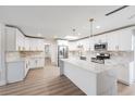 Bright kitchen featuring white cabinets, stainless steel appliances, and a spacious island at 7607 22Nd W Ave, Bradenton, FL 34209