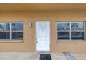 Exterior unit entrance featuring a white front door with windows on either side at 8039 Garden Dr # 105, Seminole, FL 33777