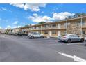 Exterior view of a two-story building with ample parking at 8039 Garden Dr # 105, Seminole, FL 33777