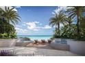 Beautiful outdoor spa area with lounge chairs, two hot tubs and a view of the ocean framed by palm trees at 805 S Gulfview Blvd # 305B, Clearwater, FL 33767