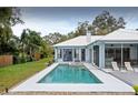Backyard in ground pool and spa with large deck and screened in back porch at 8701 Lake Calm Ln, Odessa, FL 33556