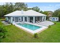 Aerial view of backyard with private in ground pool, large deck and screened in porch at 8701 Lake Calm Ln, Odessa, FL 33556