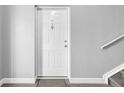 A gray doormat in front of a white front door with silver accents at 9130 Tudor Dr # M105, Tampa, FL 33615