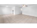 Spacious living room with tile floors and a ceiling fan at 9130 Tudor Dr # M105, Tampa, FL 33615