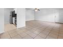 A spacious living room area with a ceiling fan at 9130 Tudor Dr # M105, Tampa, FL 33615