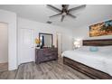 Bright main bedroom boasts a ceiling fan, and sleek, modern wood flooring at 9647 Summers Cay Cir, Thonotosassa, FL 33592