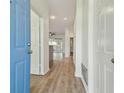 Bright hallway with modern flooring, leading to the main living areas and bedrooms at 105 1St Se Ave, Lutz, FL 33549