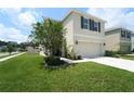 Charming two-story home with a well-kept lawn, flower beds and an attached two-car garage at 10826 Trailing Vine Dr, Tampa, FL 33610