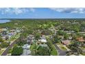 An aerial view highlighting neighborhood of quaint homes nestled among lush greenery and bay at 11764 Pinedale Ave, Seminole, FL 33772