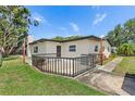 The backyard patio is surrounded by dark metal rails, providing an outdoor space for relaxing and entertaining at 11764 Pinedale Ave, Seminole, FL 33772