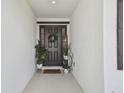 Welcoming home entrance featuring a decorative door, plants, and a 'Home Sweet Home' mat at 12517 Nantahala Run, Parrish, FL 34219