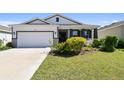 Charming home with a two-car garage, landscaped yard, and inviting curb appeal at 12517 Nantahala Run, Parrish, FL 34219
